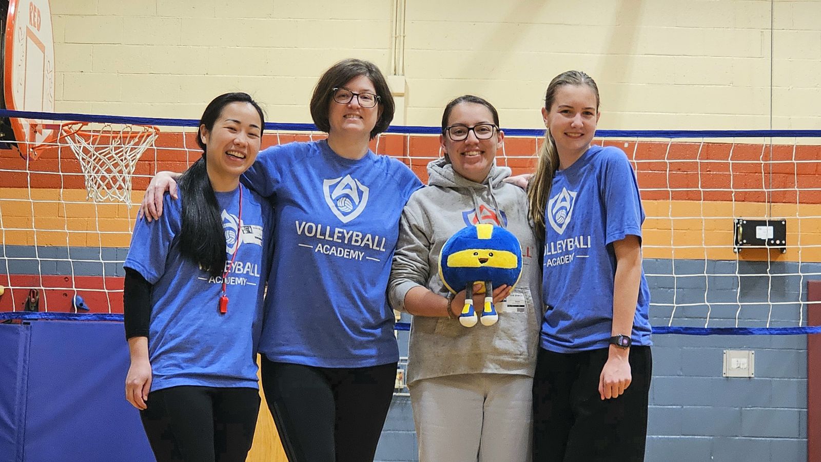 Four VA coaches smiling together